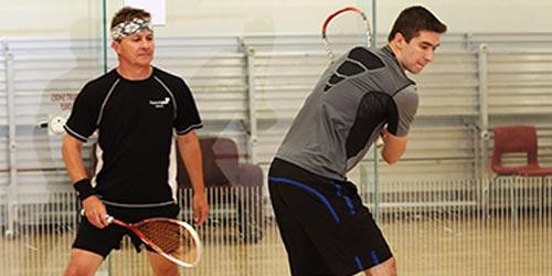 Two men playing squash