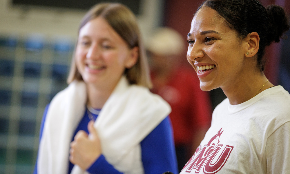 Two students smile after a work out at the gym