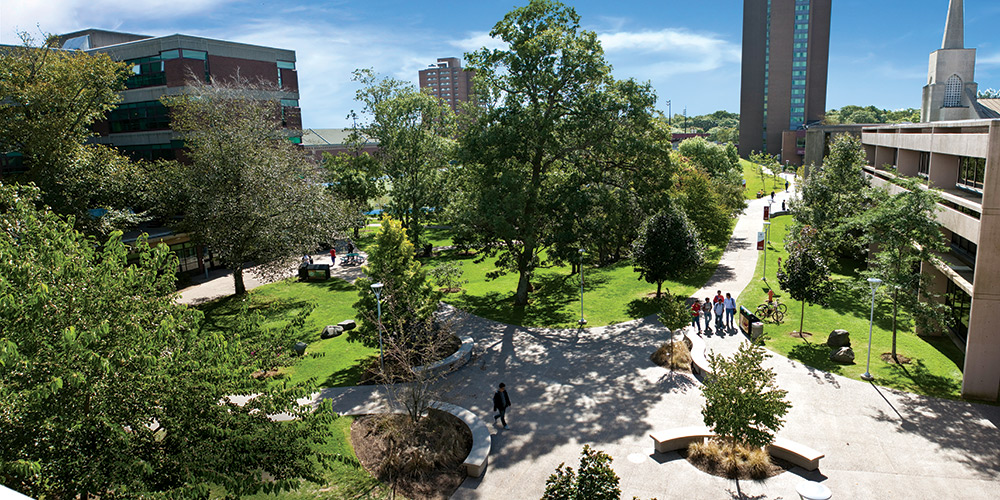 A shot from above of students walking through the quad outdoor space on campus.