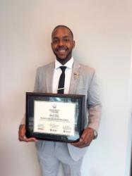 Ramon holding his award