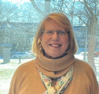 A woman posing for a photo outside during the winter