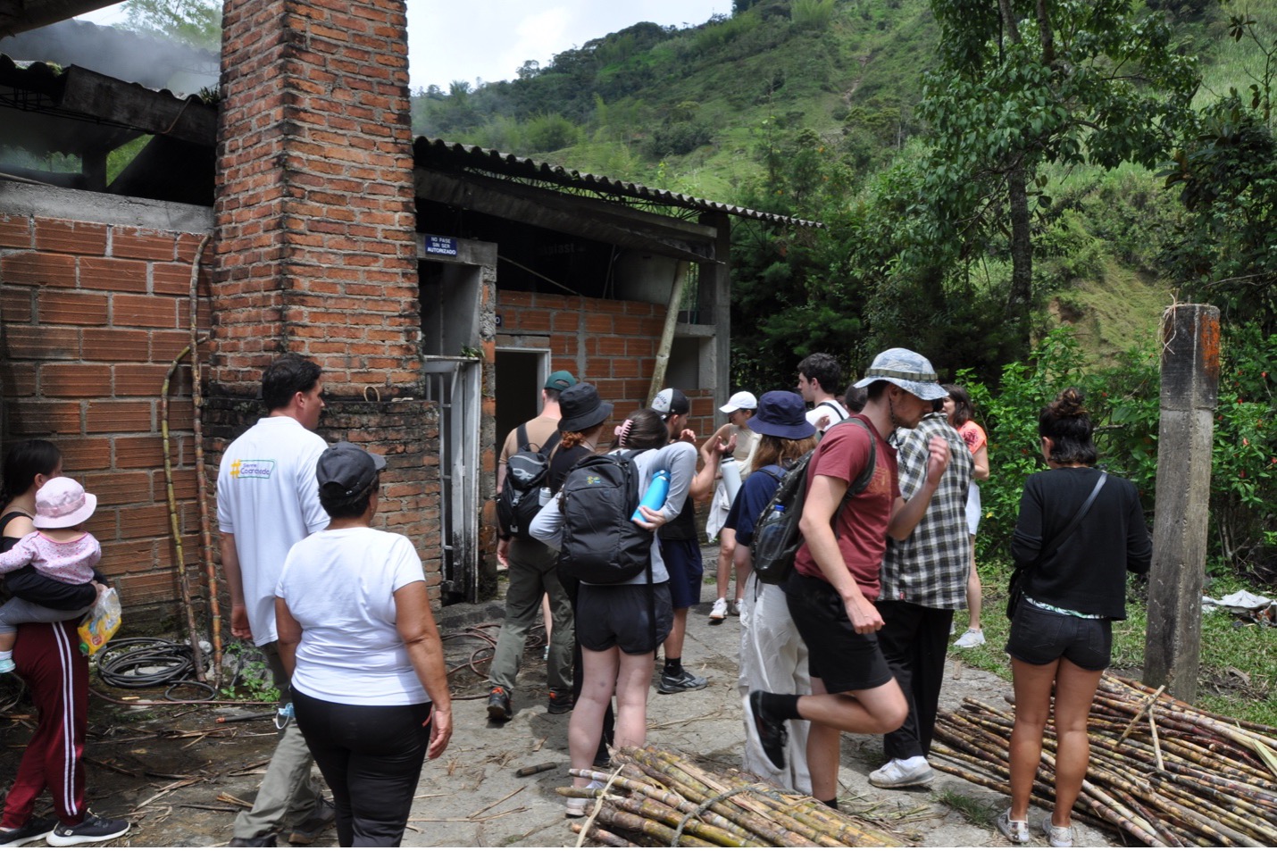 A group of students entering a sugarcane processing plant